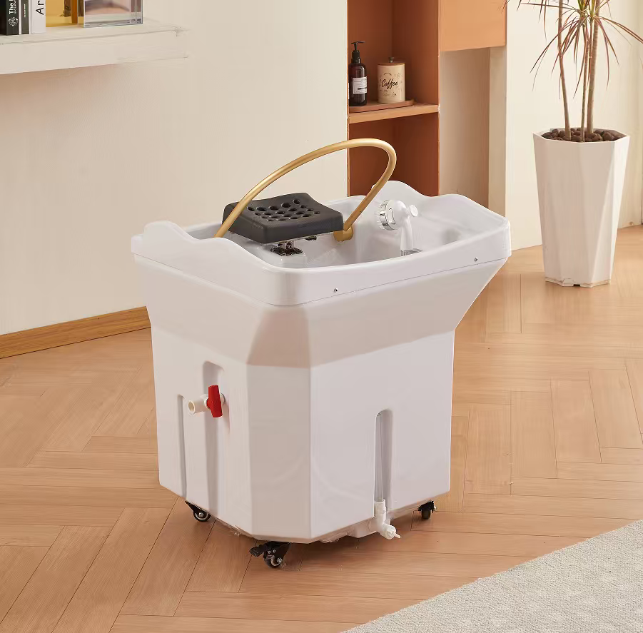 Portable white salon shampoo basin on wheels with a curved neck rest and faucet, set on a wood floor